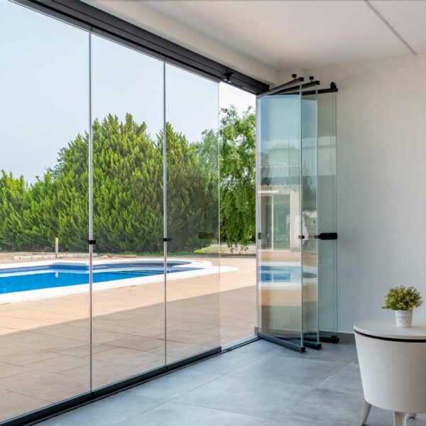 Folding glass curtain with pool in the background